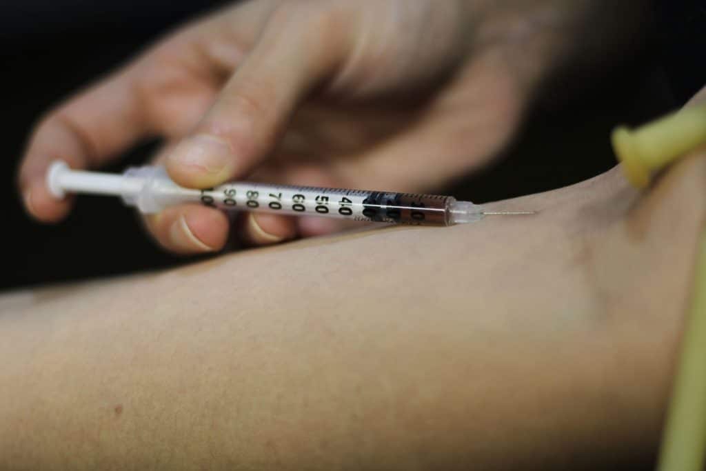 injecting drugs into arm