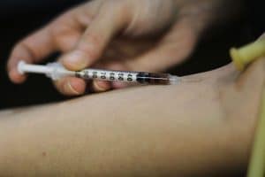 injecting drugs into arm